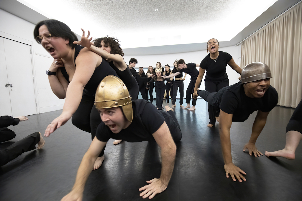 Actors crawl on the floor and appear to be yelling in mid-performance